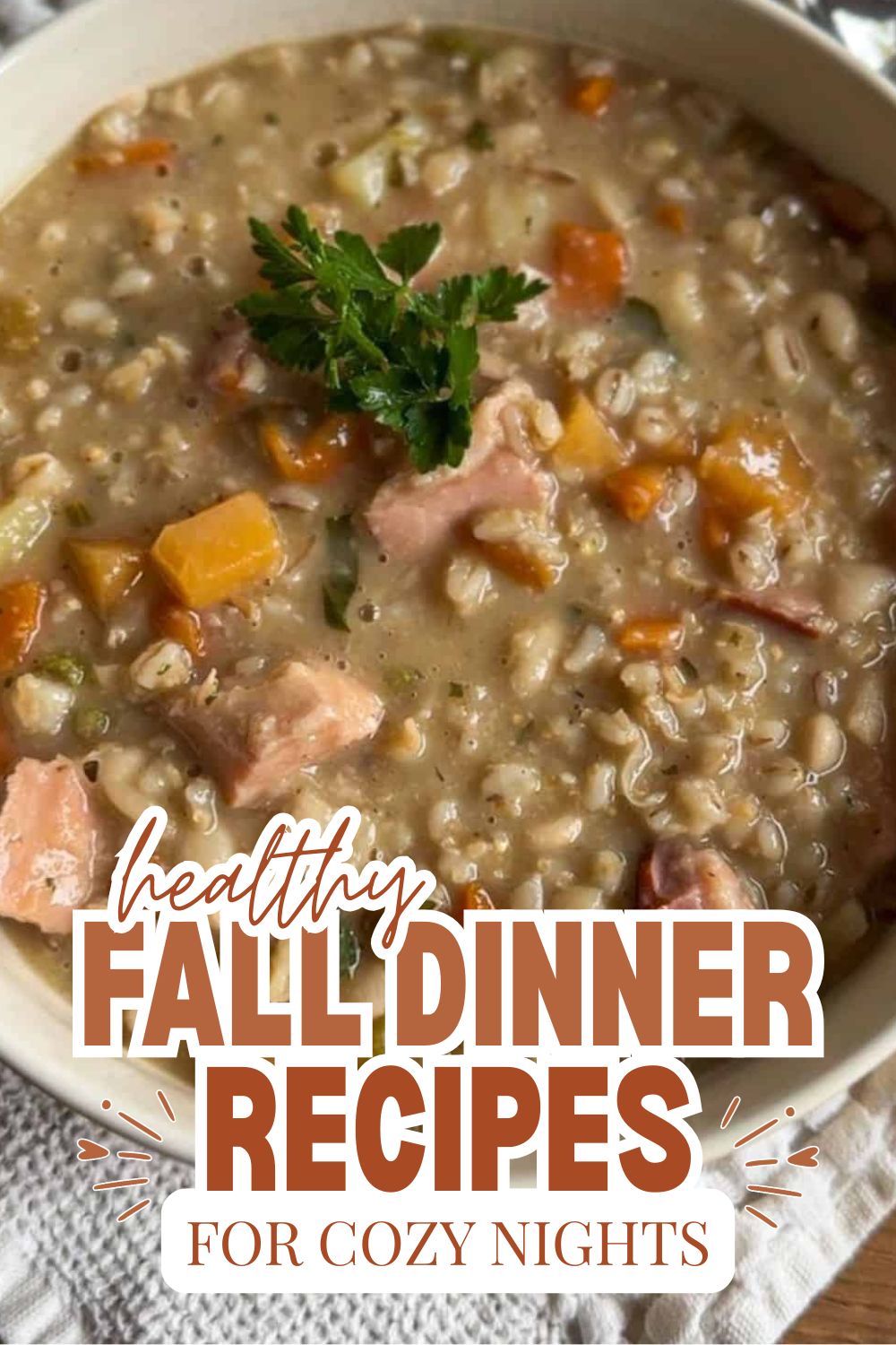 Hearty fall dinner soup with vegetables and herbs in a bowl.