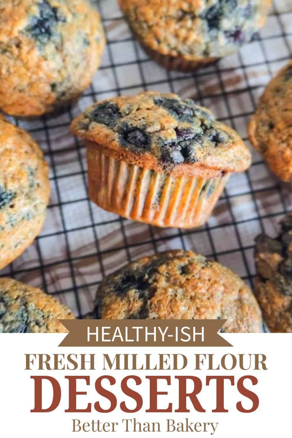 Freshly baked blueberry muffins made with fresh milled flour on cooling rack.