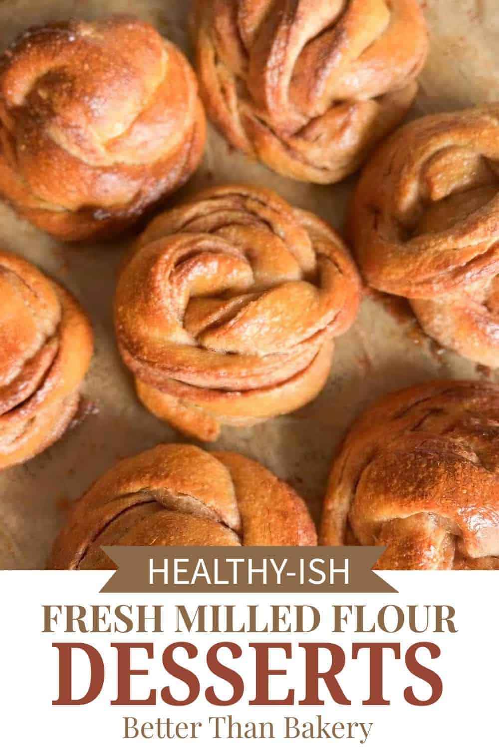 Close-up of freshly baked cinnamon rolls with golden crust and swirls.