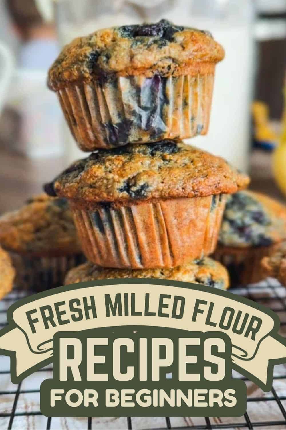 Stack of blueberry muffins made with fresh milled flour on cooling rack.