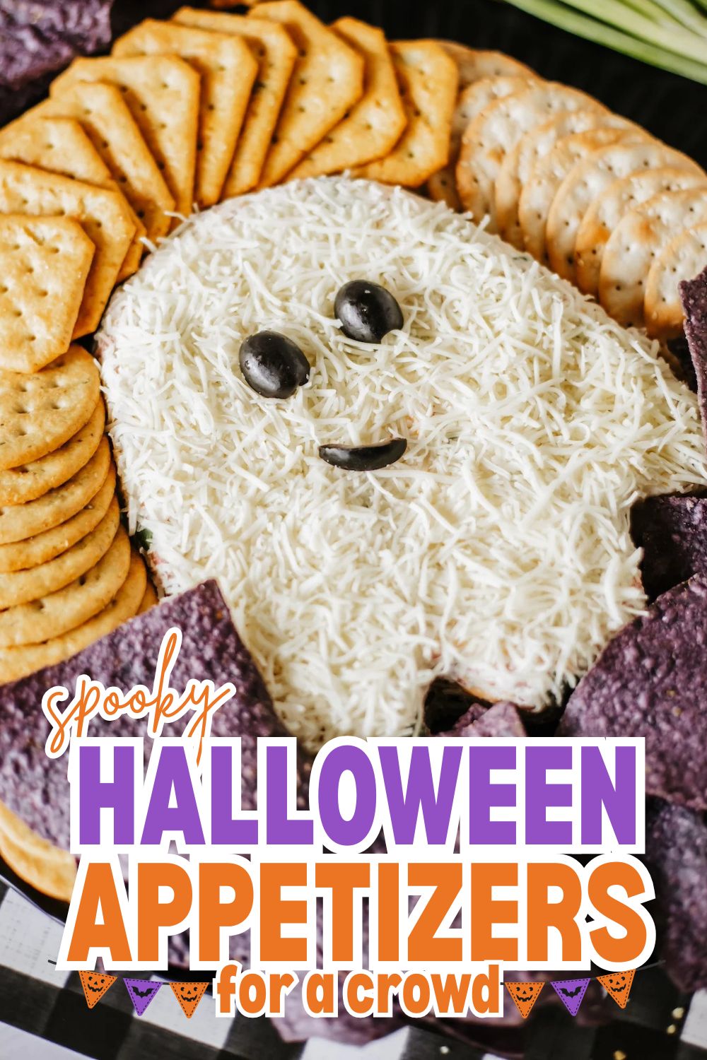 Spooky Halloween cheese platter with crackers and cheese face.