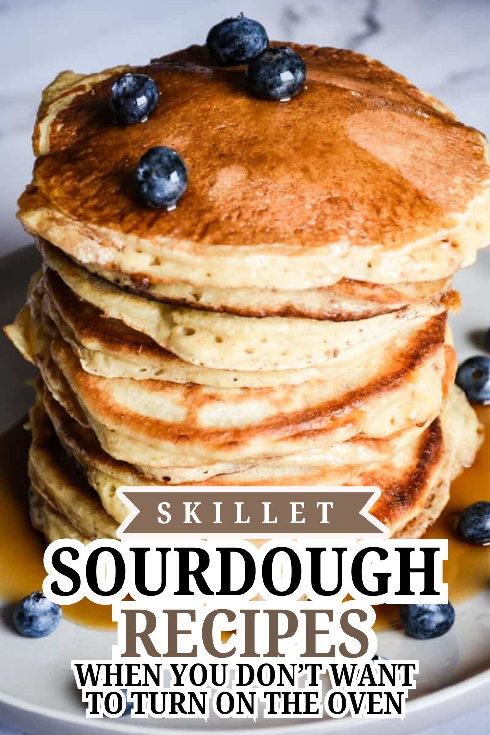 Stack of sourdough pancakes topped with blueberries, perfect for skillet sourdough recipes.