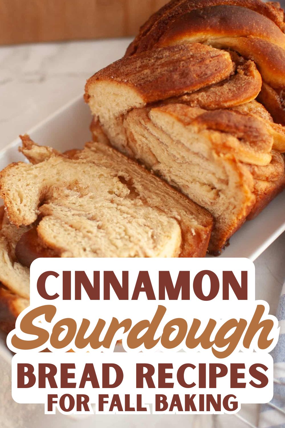 Close-up of sliced cinnamon sourdough bread on a white plate.