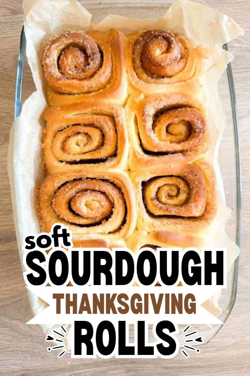 Freshly baked sourdough cinnamon rolls in a baking dish.