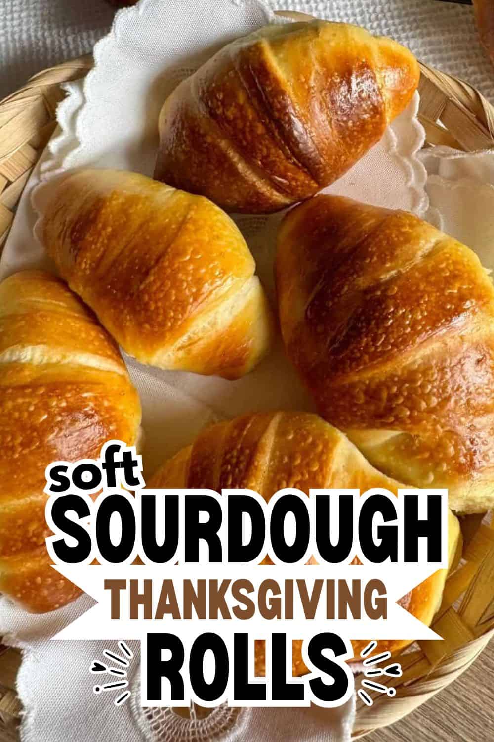 Golden-brown sourdough rolls in a basket for Thanksgiving feast.