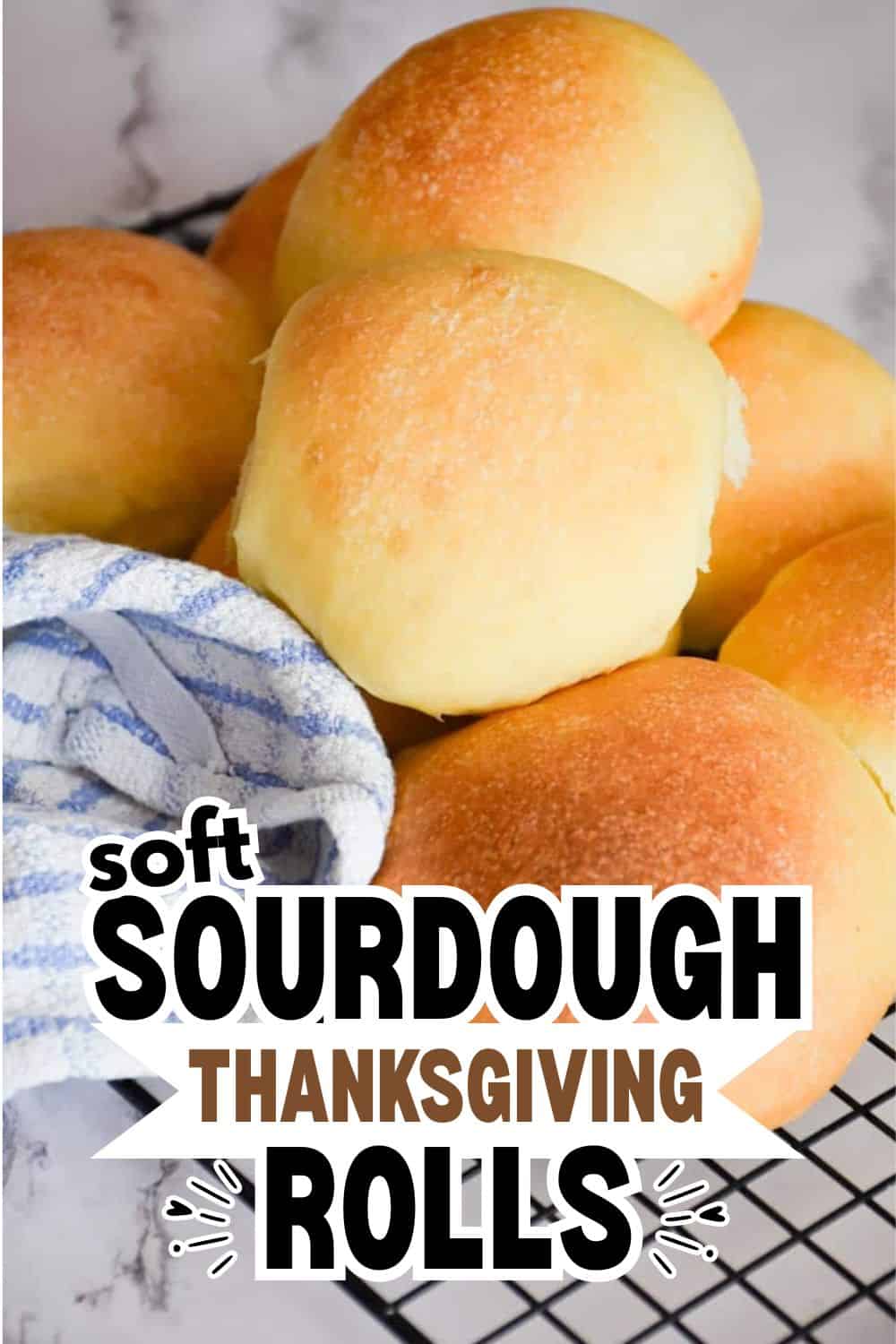 Freshly baked sourdough rolls on a cooling rack for Thanksgiving feast.