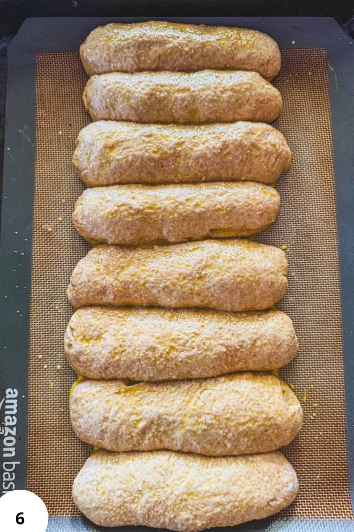 Freshly baked sourdough hot dog buns on a baking sheet for optimal image SEO.