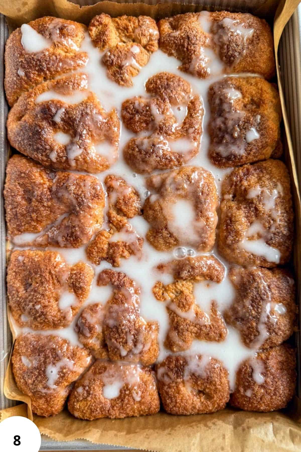 Close-up of cinnamon roll pull-apart focaccia with icing drizzle.