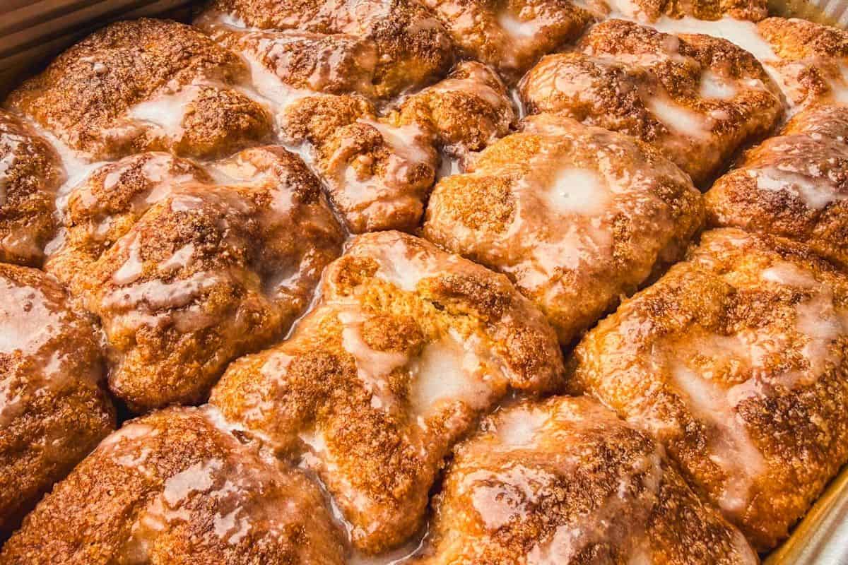 Close-up of cinnamon roll pull-apart focaccia with glaze drizzle.