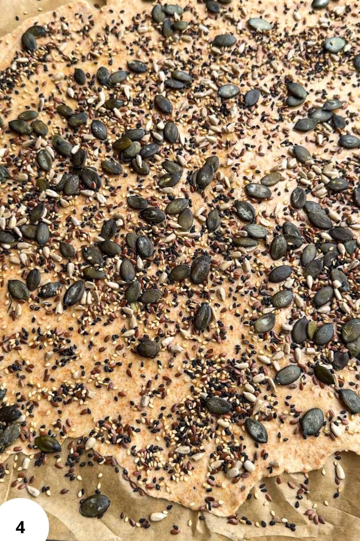 Seed and grain-topped sourdough crackers for healthy snacking.