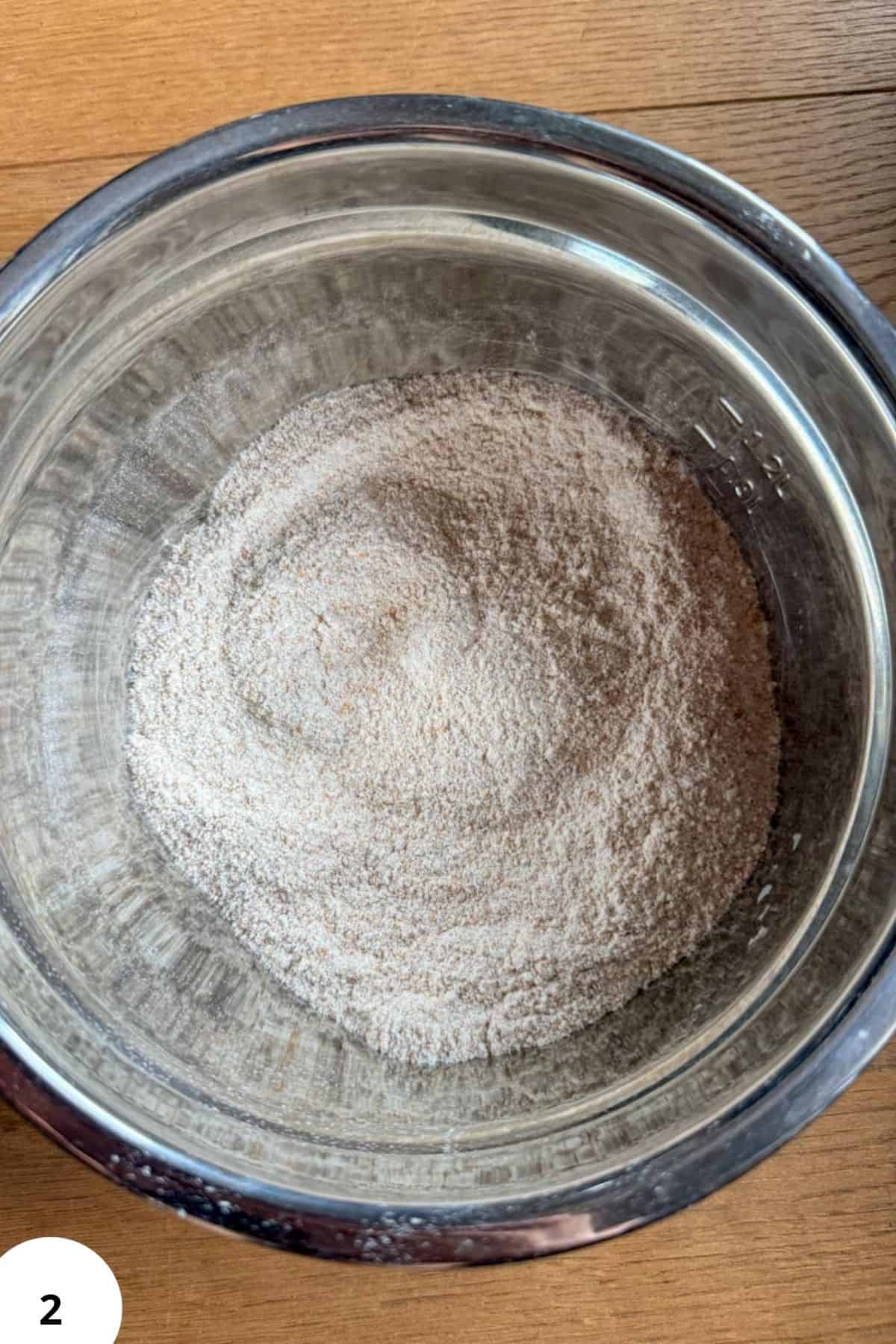 Freshly milled flour in a metal bowl for zucchini bread baking.