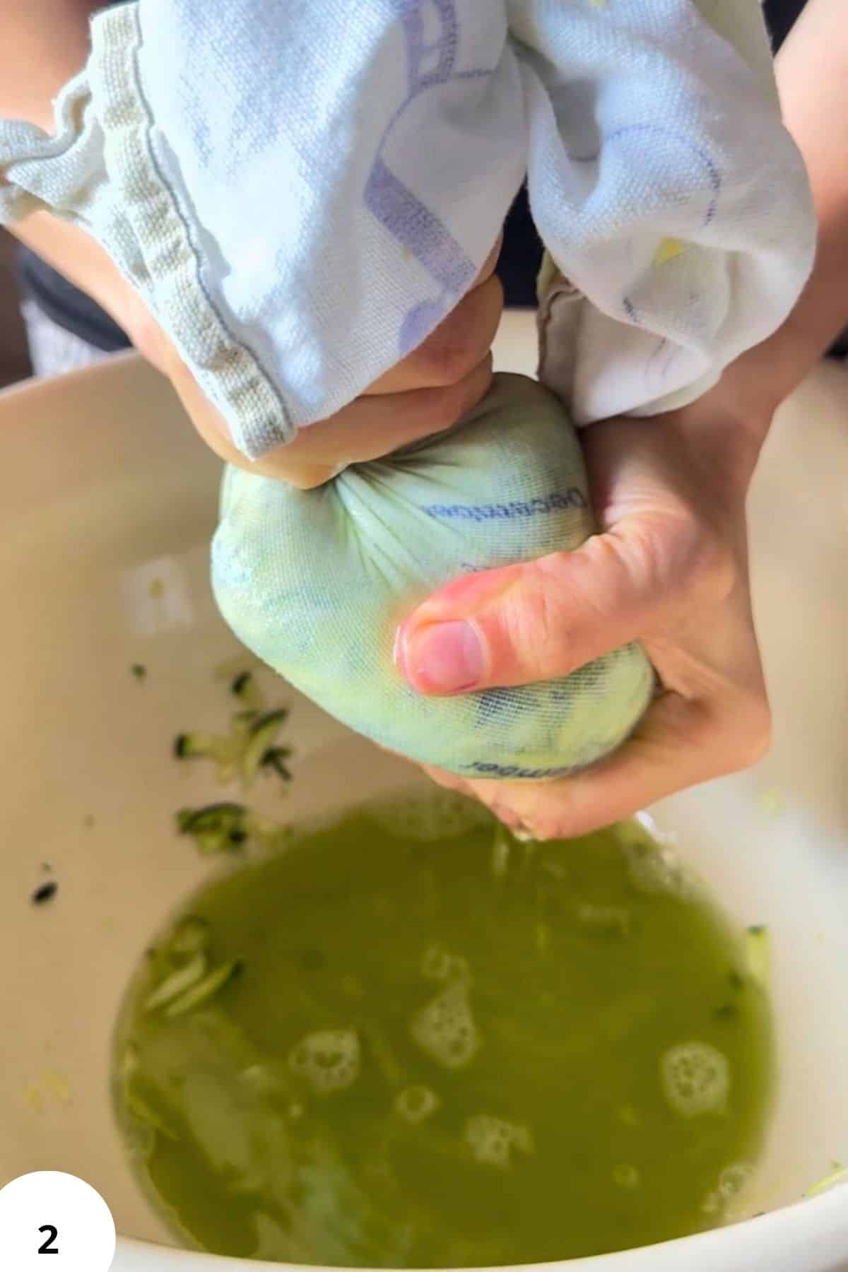 Child squeezing fresh zucchini for zucchini fritters.