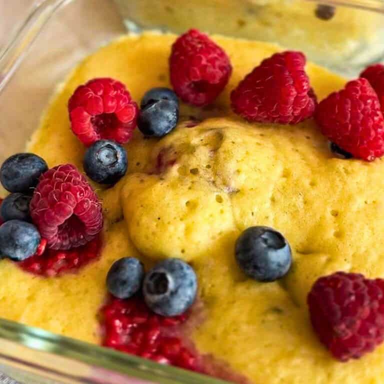 Close-up of sourdough discard pancake bowls topped with raspberries and blueberries.