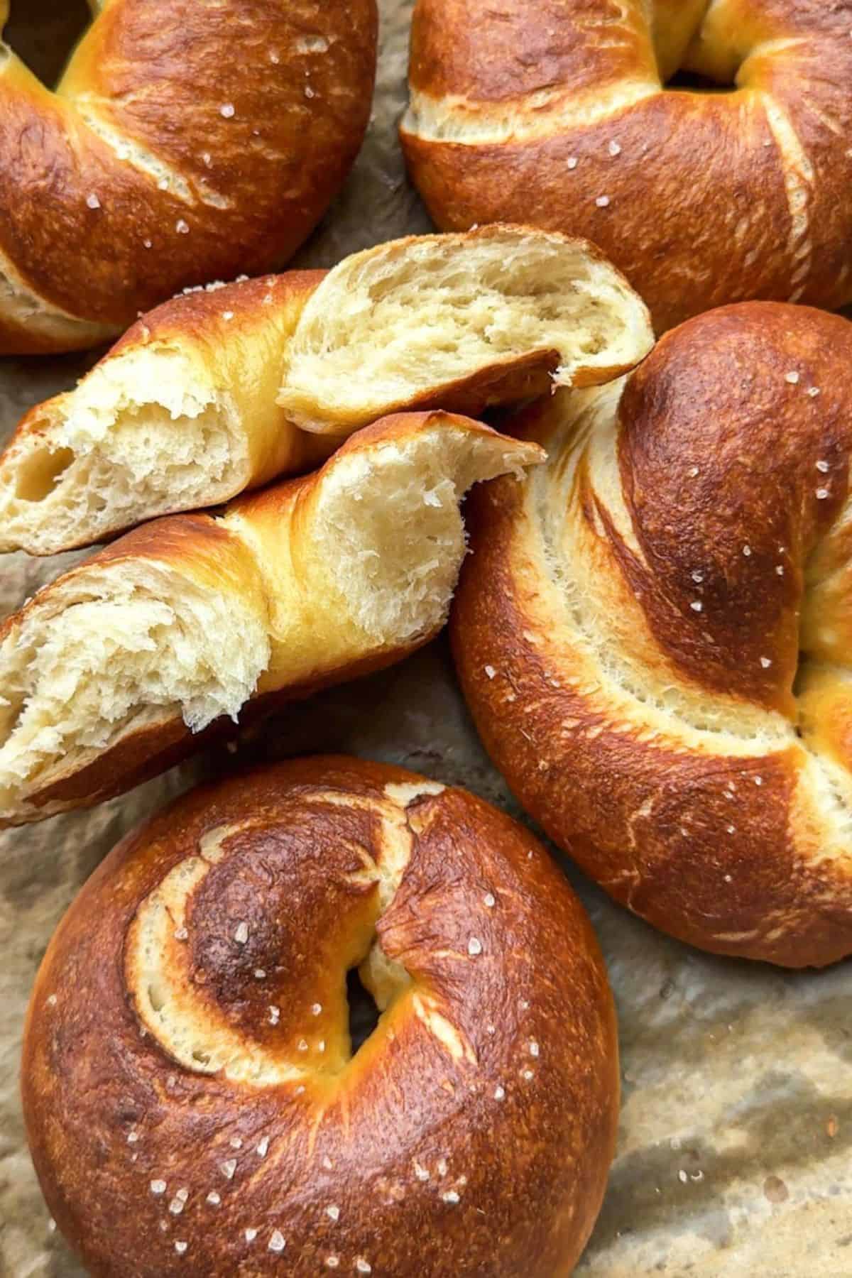 Close-up of golden-brown bagels with a soft interior and crispy crust.