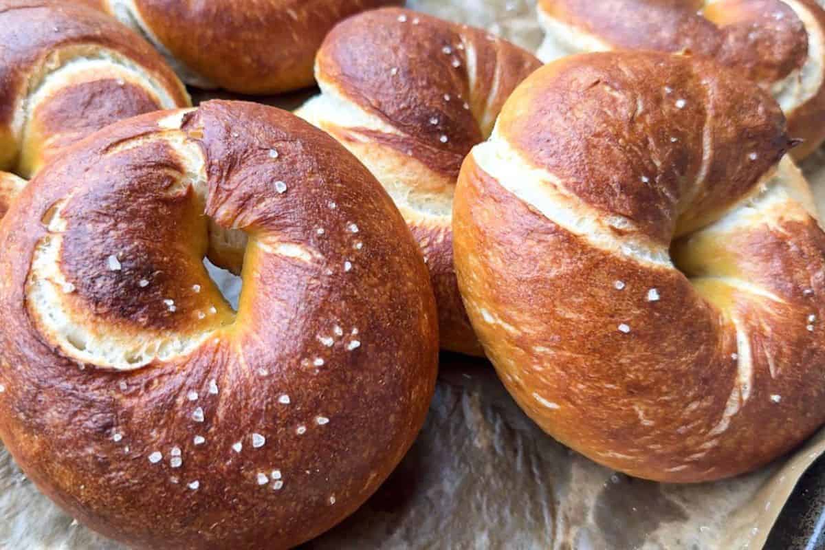 Close-up of golden-brown bagels with salt crystals on top.