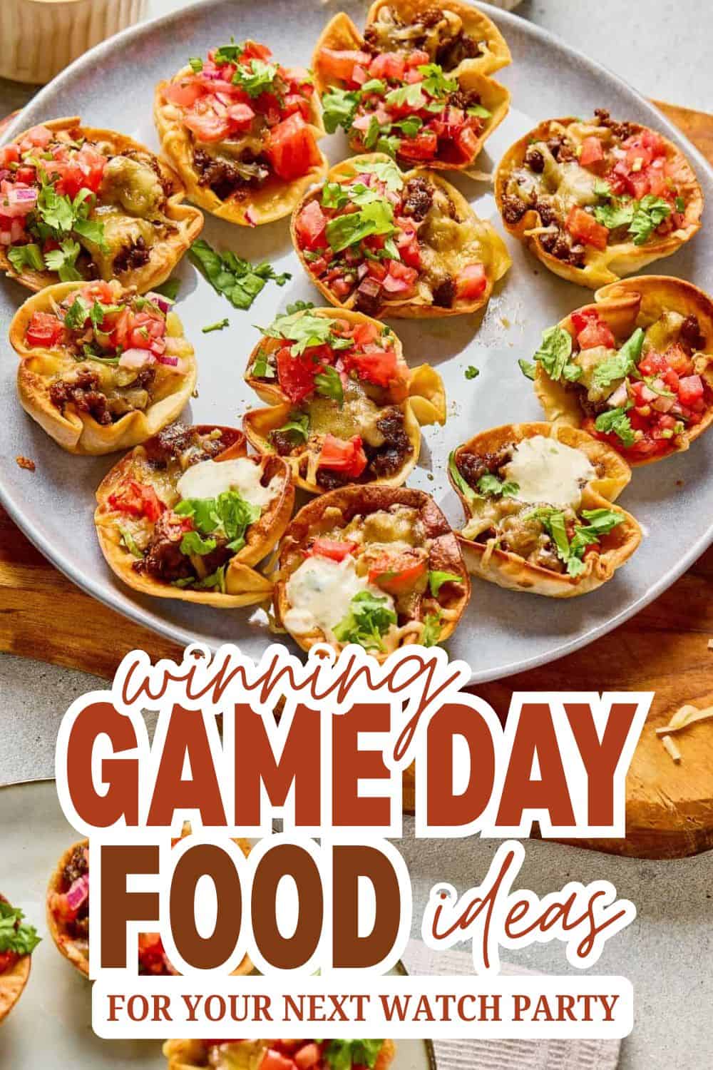 Mini taco bites with beef, cheese, and fresh herbs on a plate.