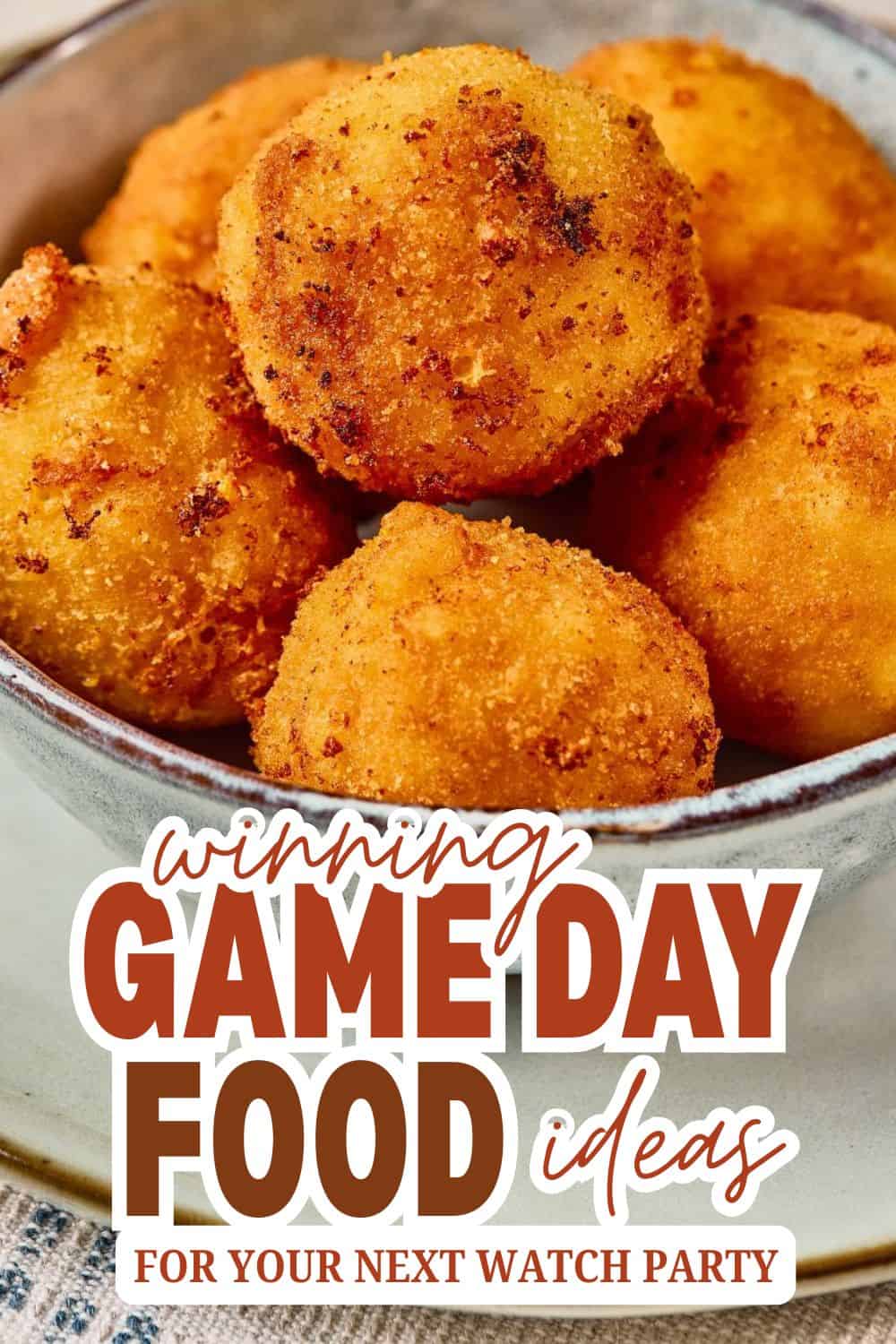 Crispy golden cheese balls in a bowl, perfect for game day snacks.