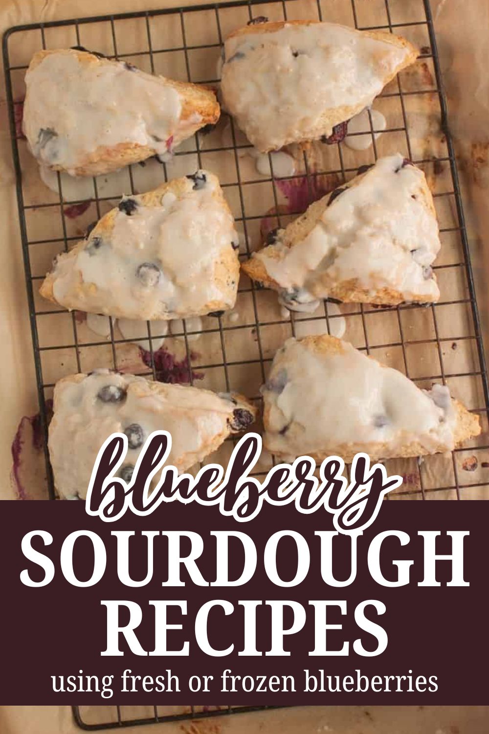 Fresh blueberry sourdough pastries on a cooling rack with blueberry filling.