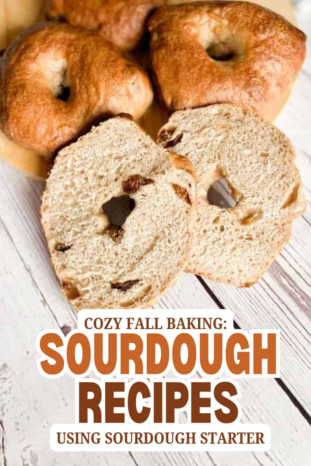Freshly baked sourdough bread with bagels and slices on a wooden surface.