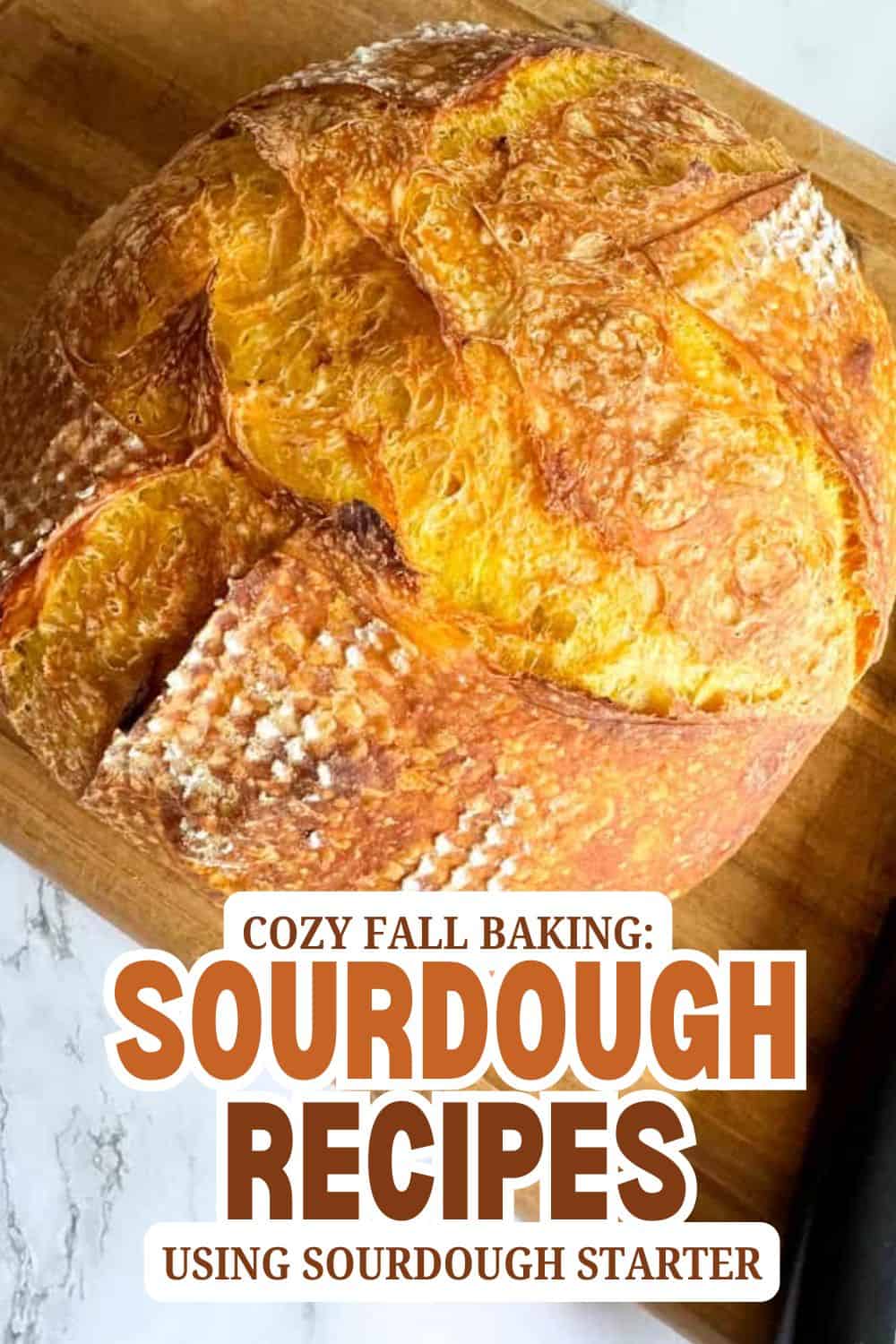 Freshly baked sourdough bread with a golden crust on a wooden board.