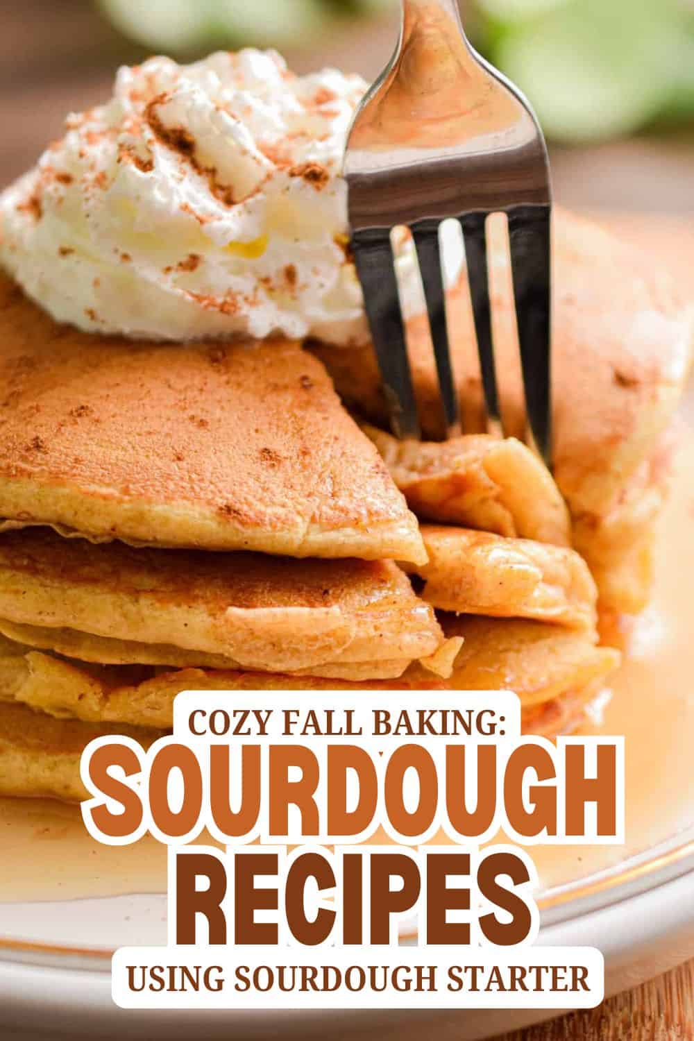 Stack of sourdough pancakes with whipped cream and fork for breakfast.
