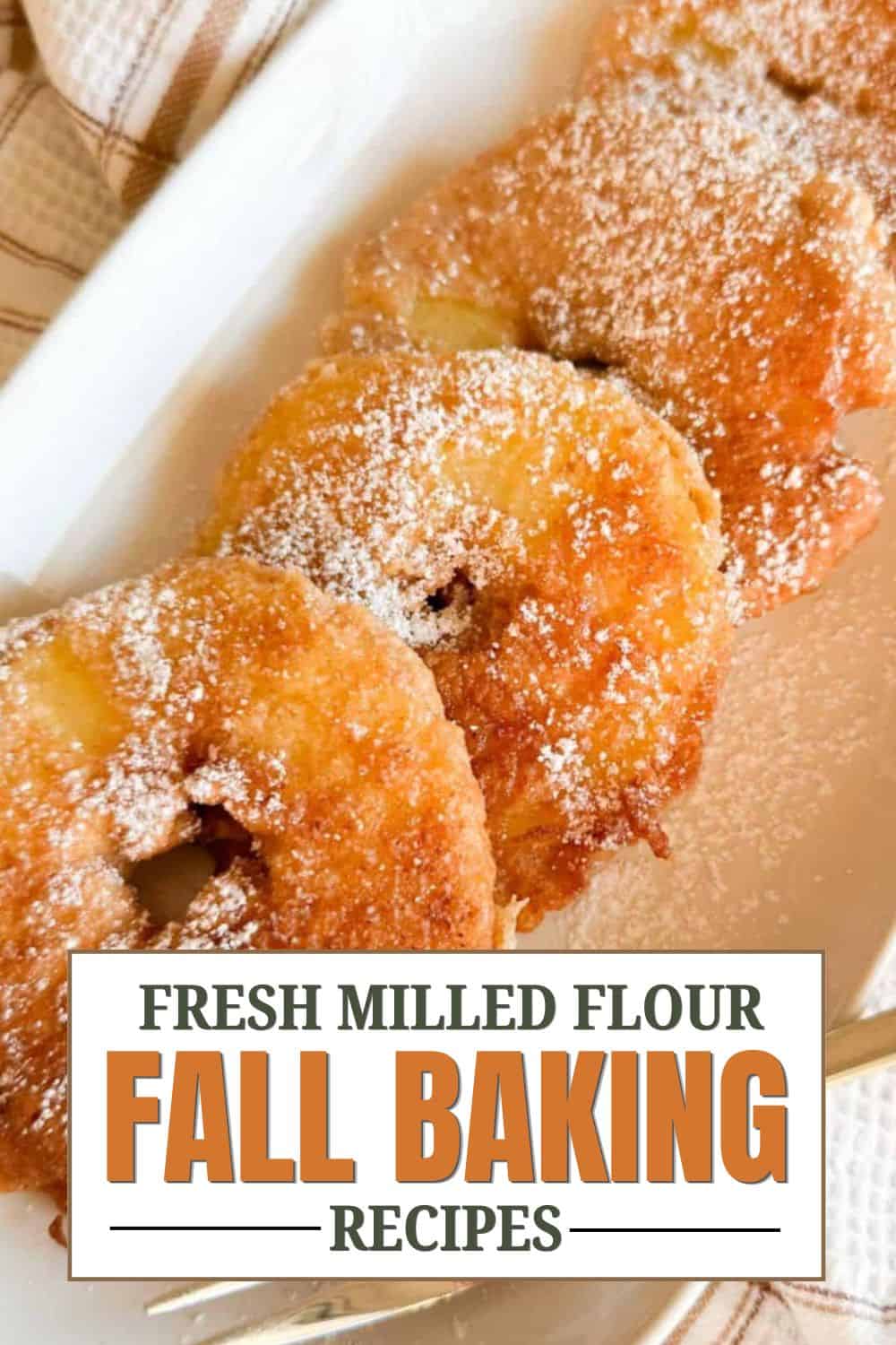 Close-up of golden fried doughnuts with powdered sugar for fall baking.