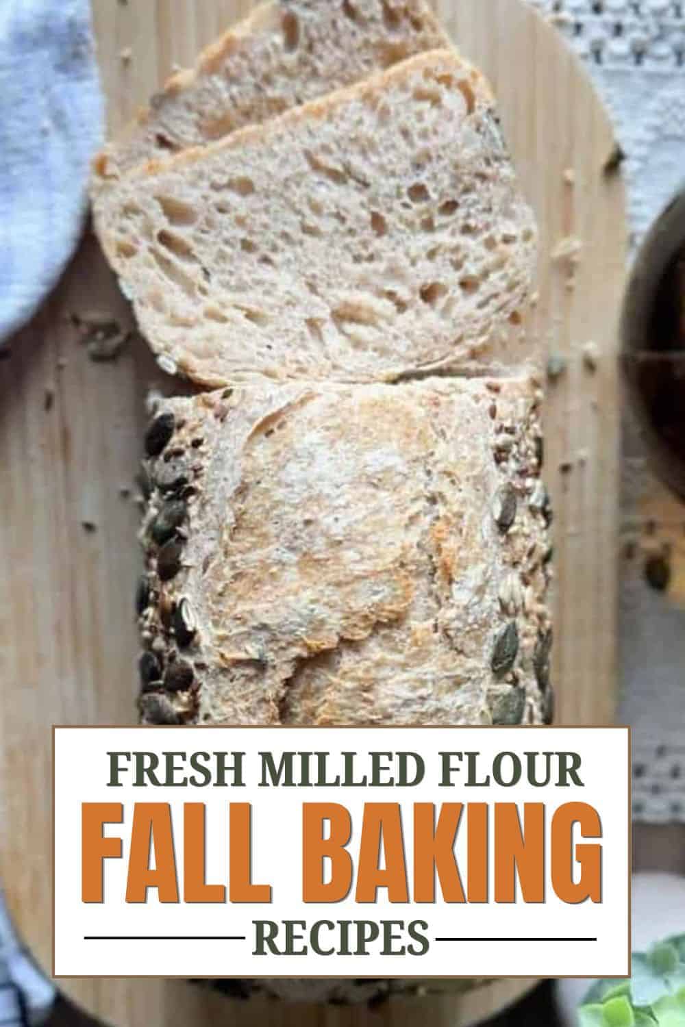 Sliced rustic bread made with fresh milled flour on a wooden board.