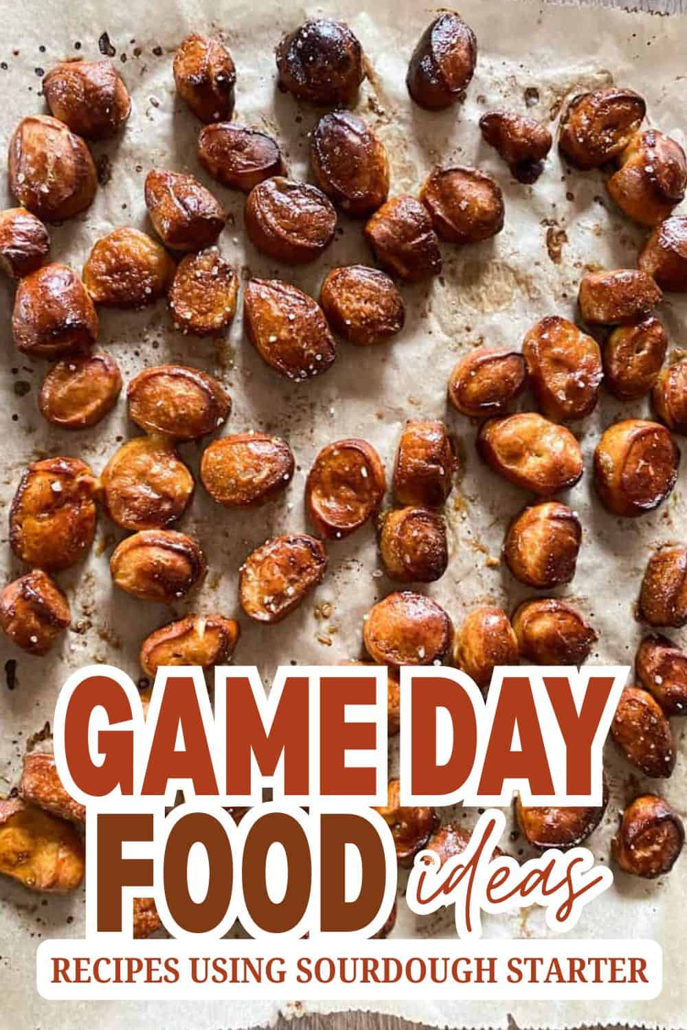 Roasted sourdough starter nuts on parchment paper for game day snacks.