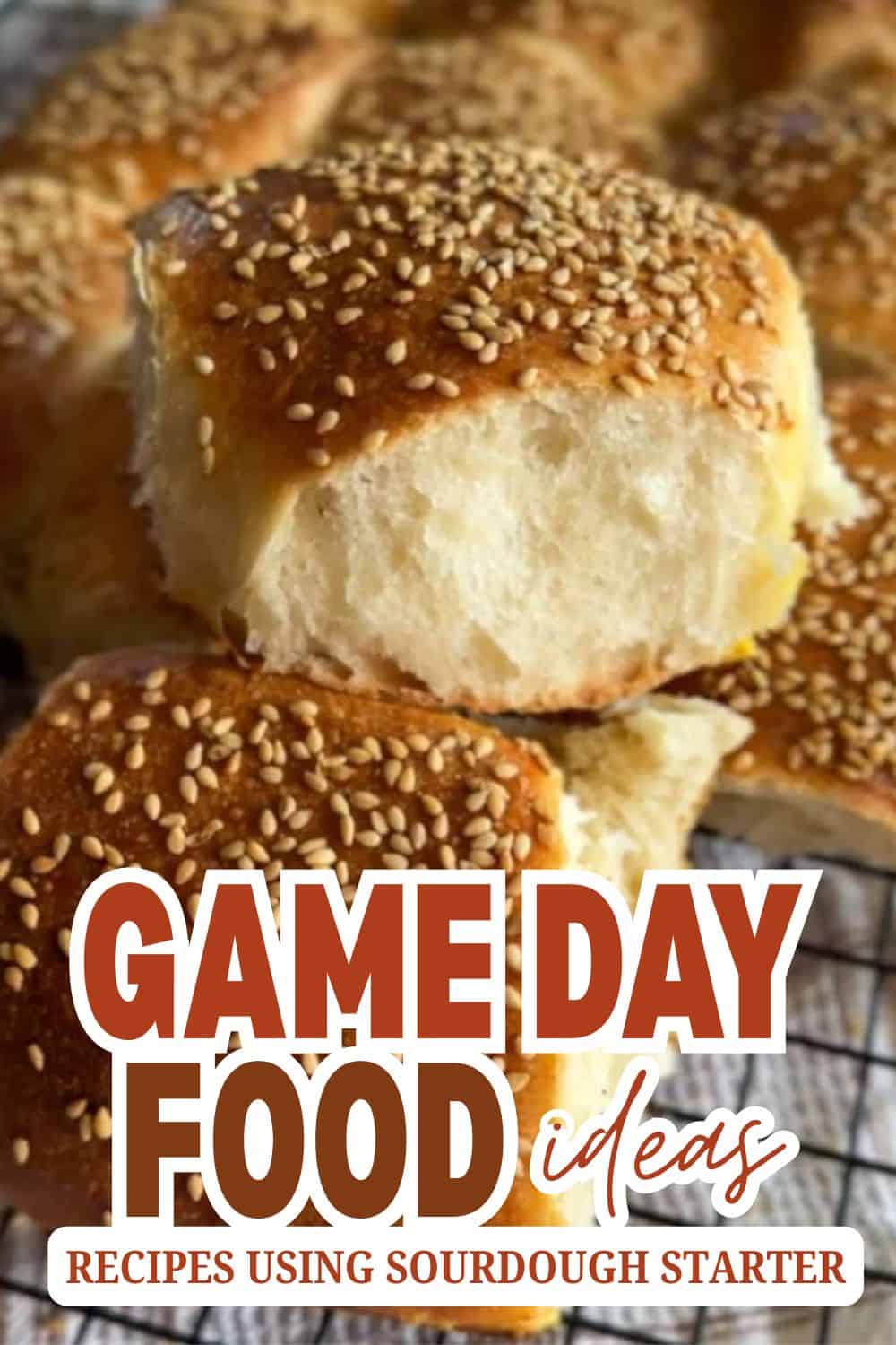 Close-up of freshly baked sourdough bread rolls with sesame seeds.