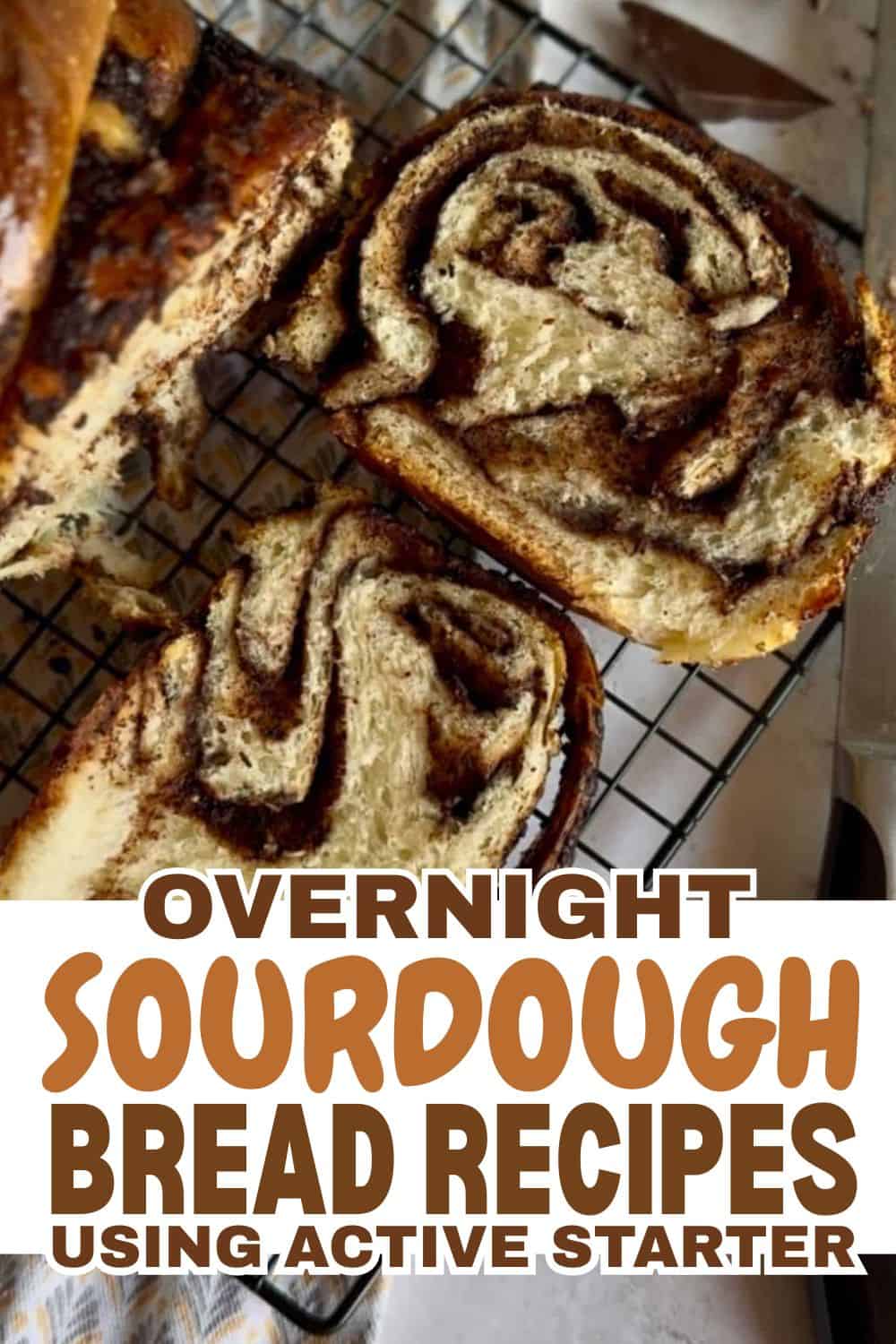 Freshly baked sourdough bread with swirled pattern on cooling rack.