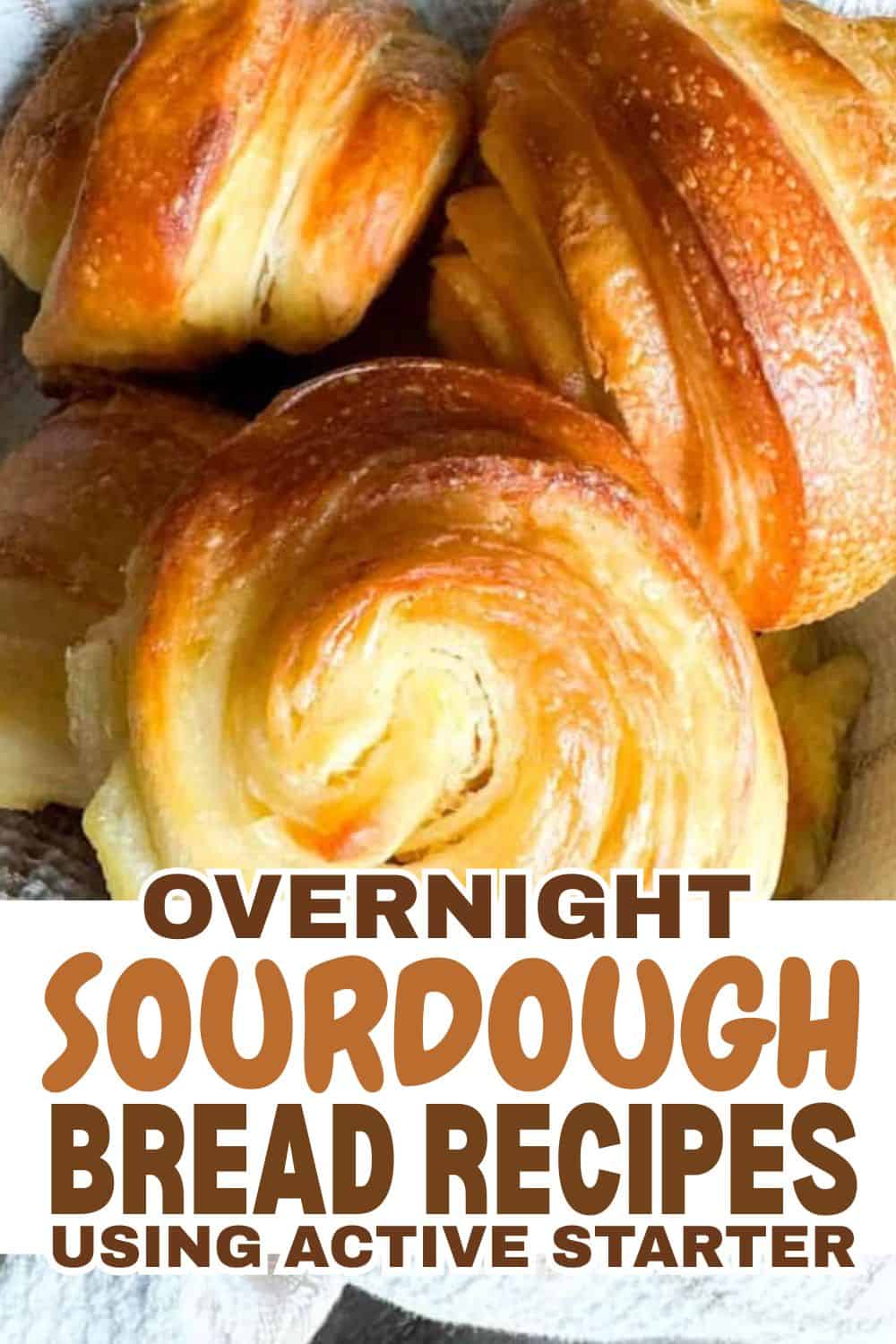 Freshly baked sourdough bread rolls with golden crusts.