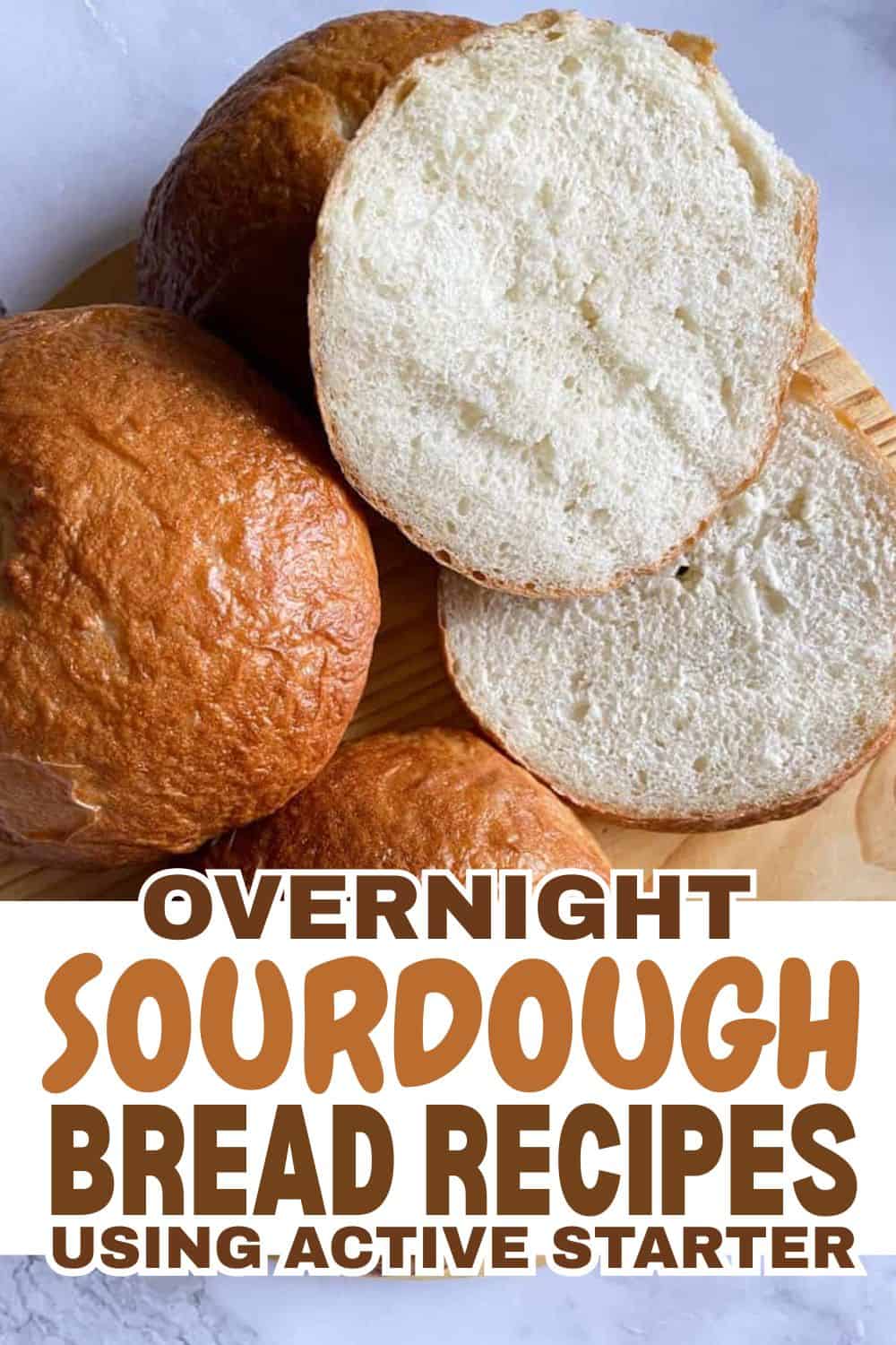 Freshly baked sourdough bread rolls with a soft interior.