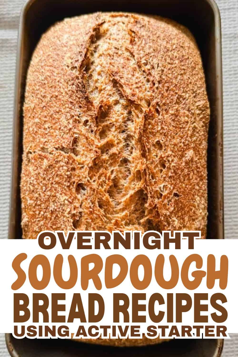 Freshly baked sourdough bread in a baking pan, ready to enjoy.