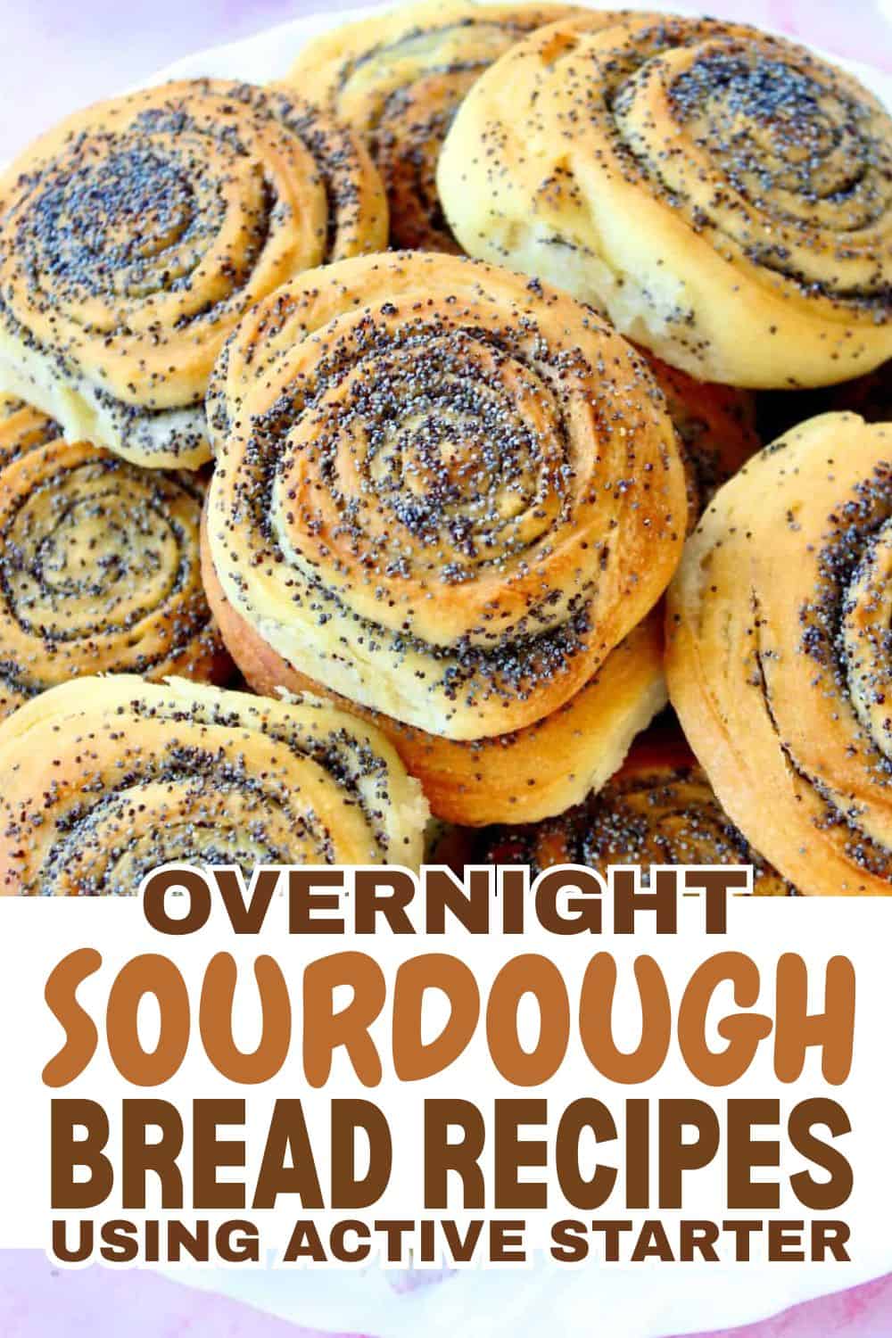 Freshly baked sourdough bread rolls with poppy seeds on top.