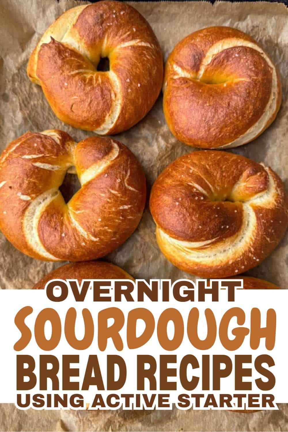 Freshly baked sourdough bagels on parchment paper for bread making.