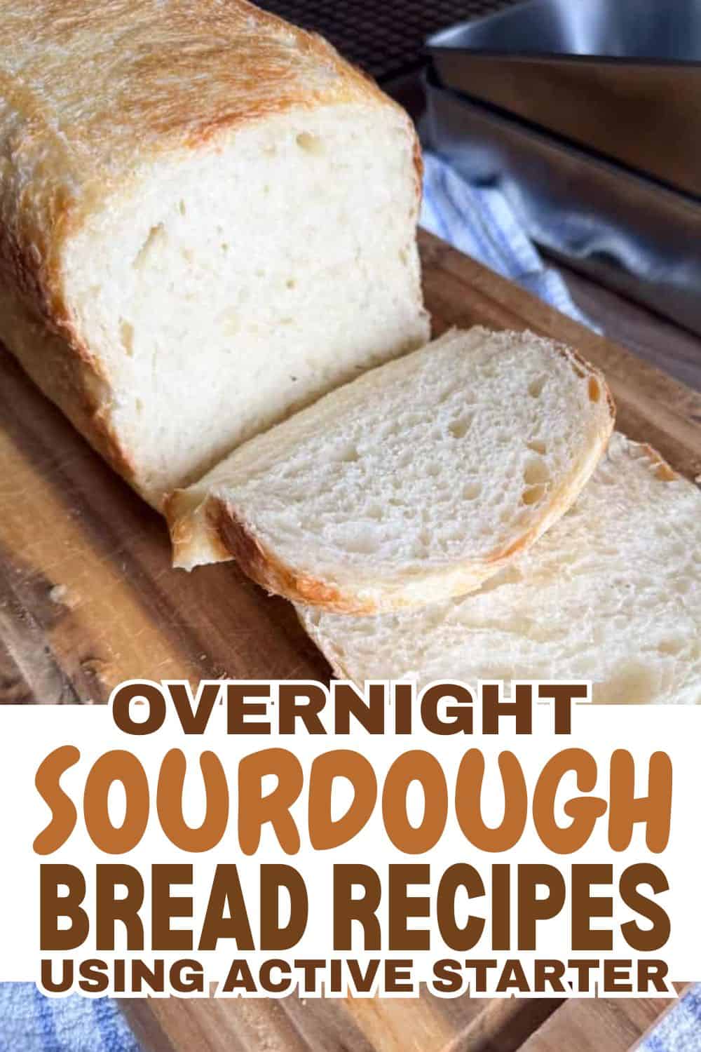 Freshly baked sourdough bread with a slice cut, on a wooden board.