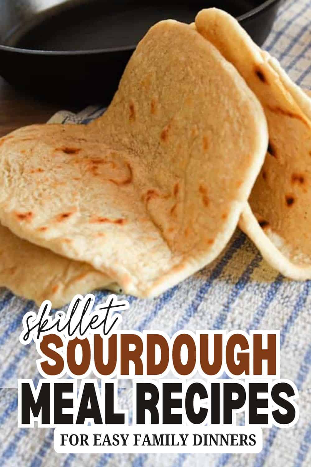 Sourdough bread slices with a crispy crust on a blue cloth.