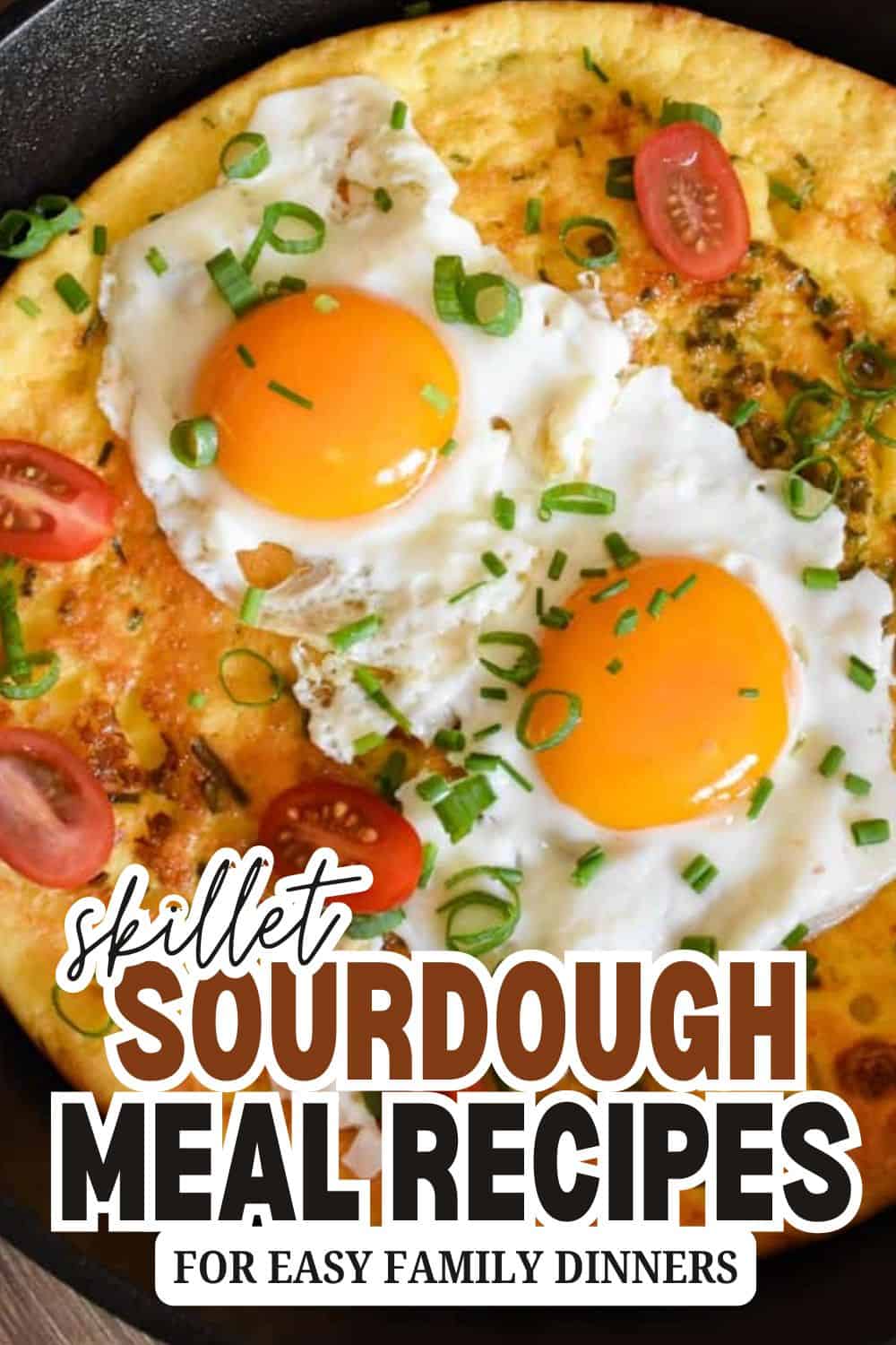 Close-up of sourdough bread with eggs, cherry tomatoes, and green onions.