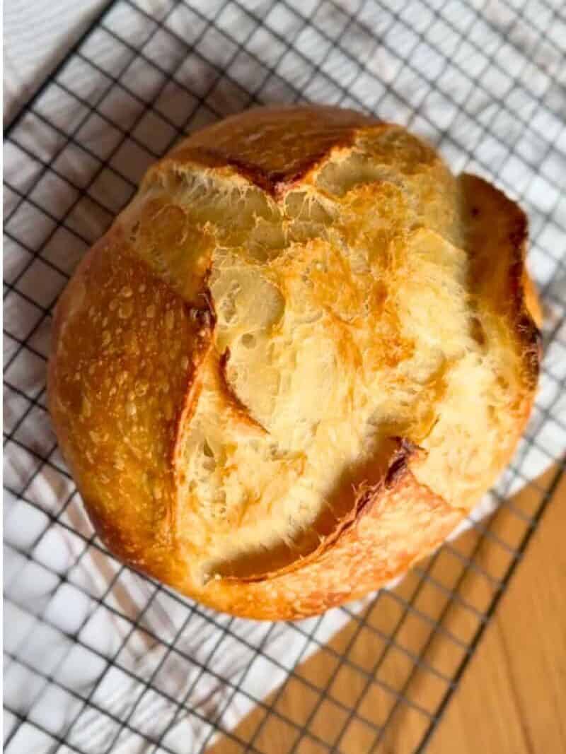 Close-up of a rustic bread loaf with a golden crust and soft interior.