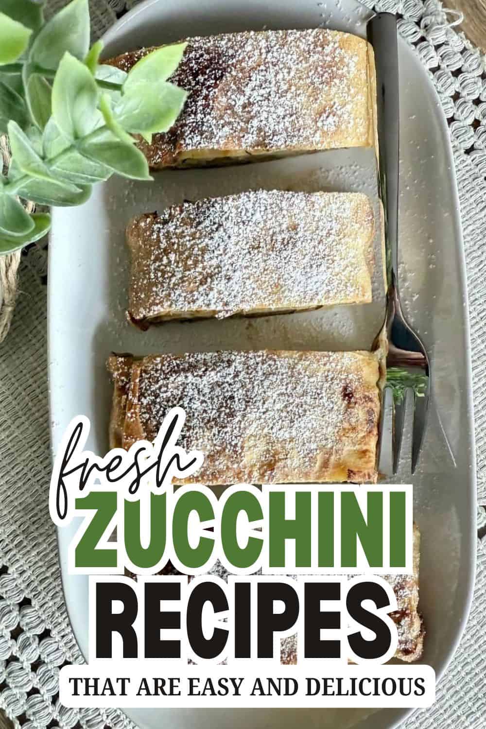 Delicious zucchini dessert slices dusted with powdered sugar on a white plate.
