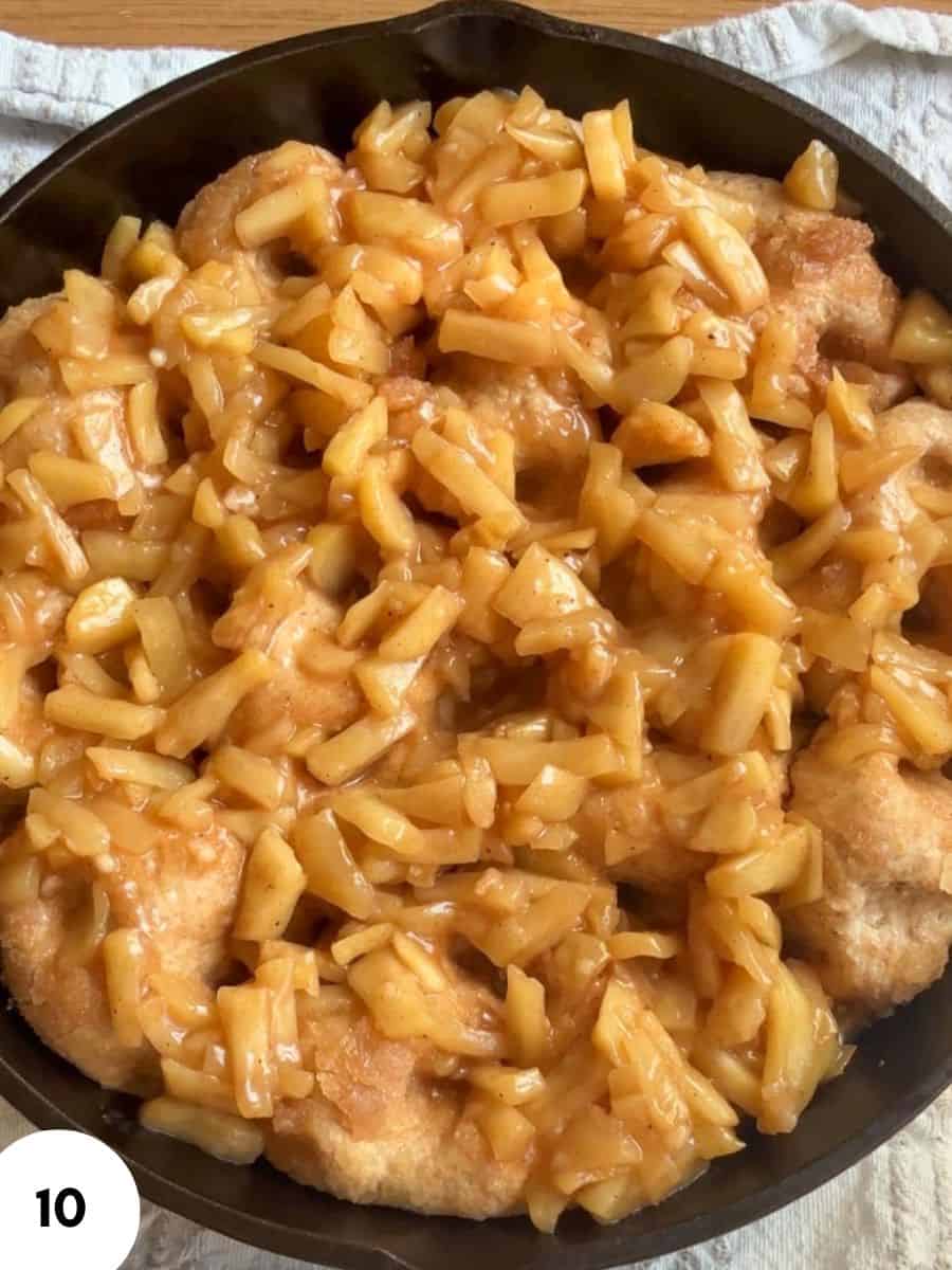 Close-up of bread with caramelized apple topping in a skillet.