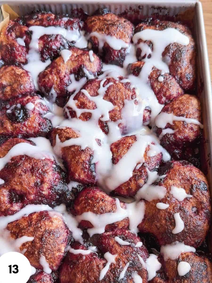 Close-up of cinnamon rolls with icing drizzle, fresh from the oven.