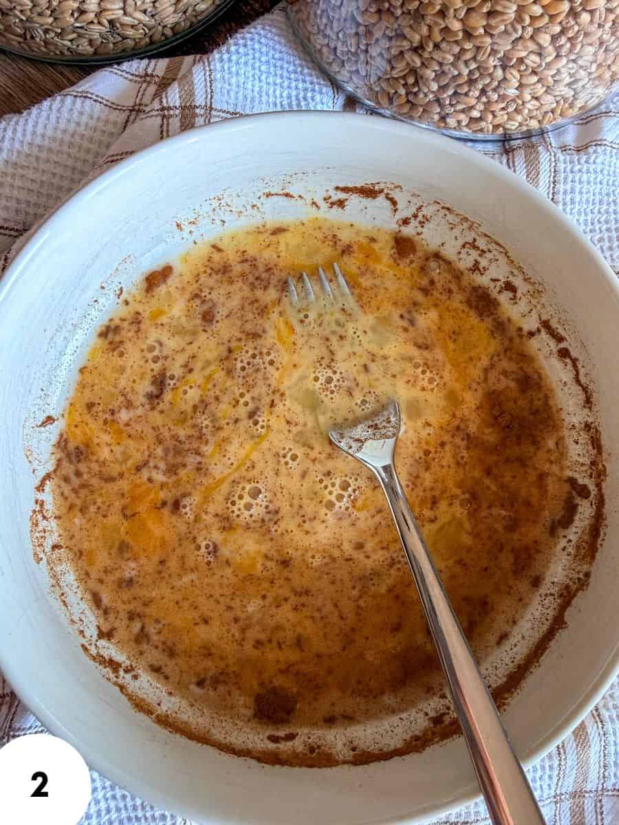 Close-up of bread dough in a bowl during fermentation process.