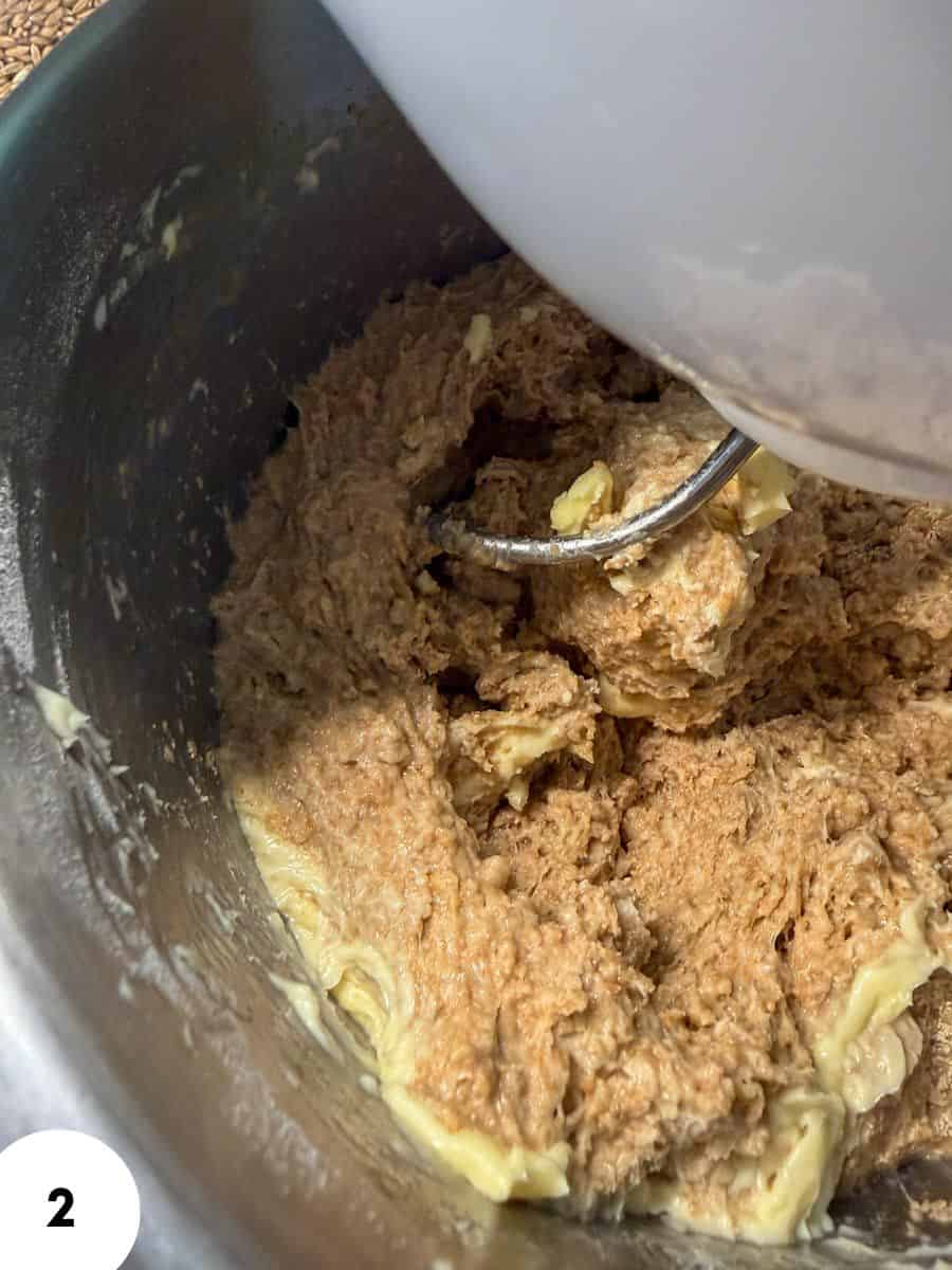 Dough being kneaded with a stand mixer for bread baking.