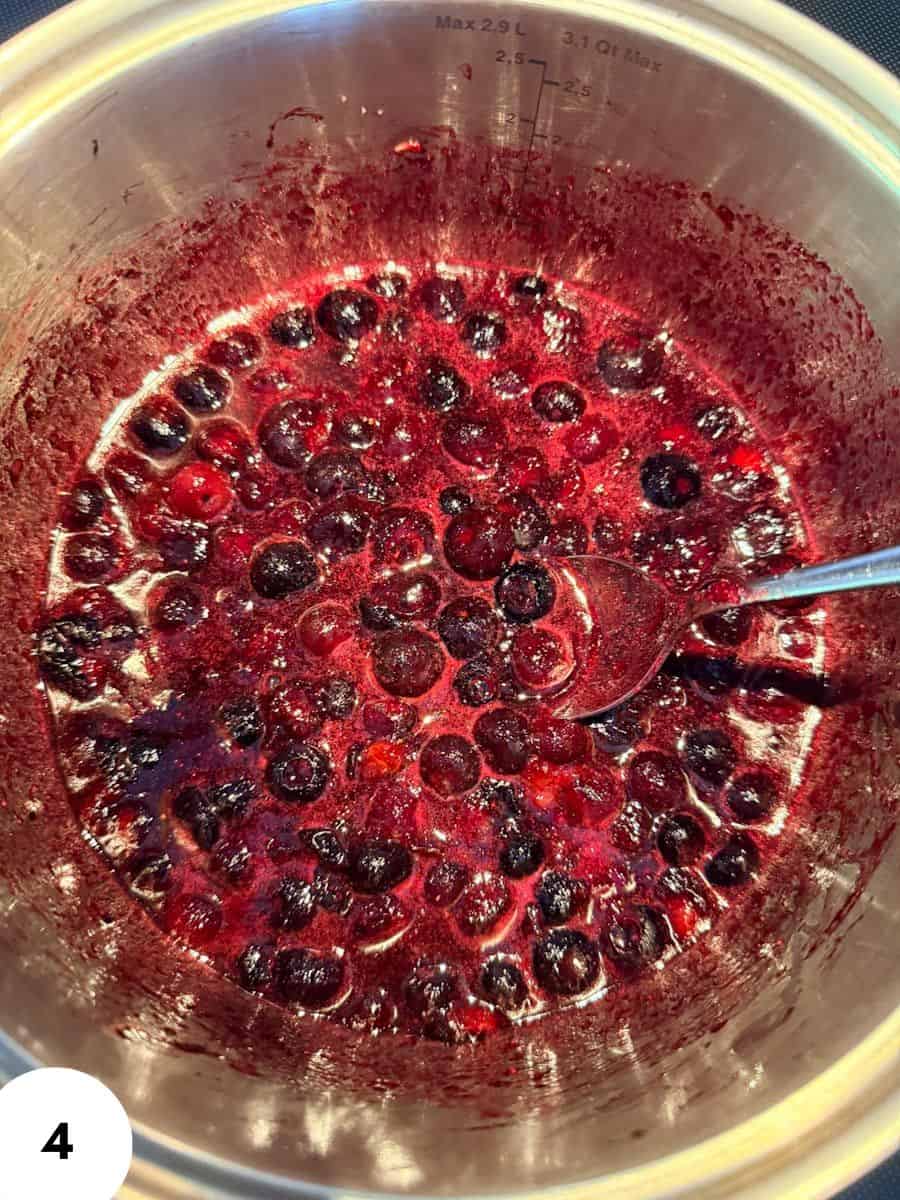 Berry jam in a glass jar with a spoon, ready for baking or spreading.