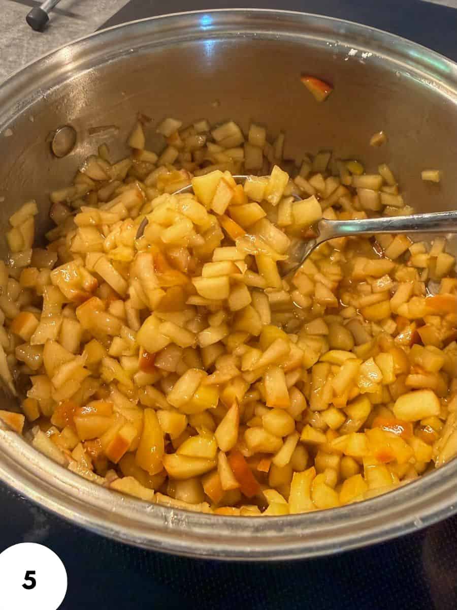 Cooked diced vegetables in a pan, ready for bread dough preparation.