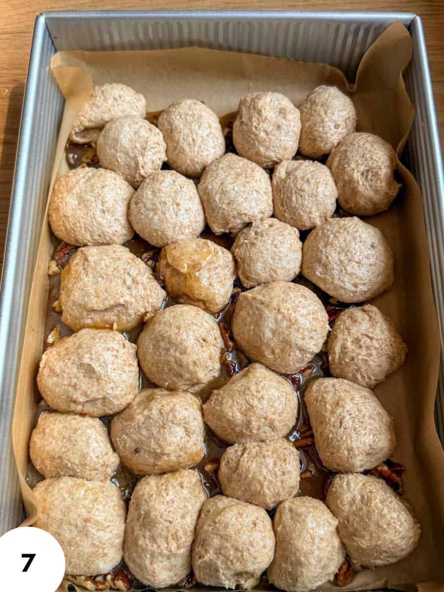 Pecan pull-apart bread dough balls in a baking pan ready for baking.
