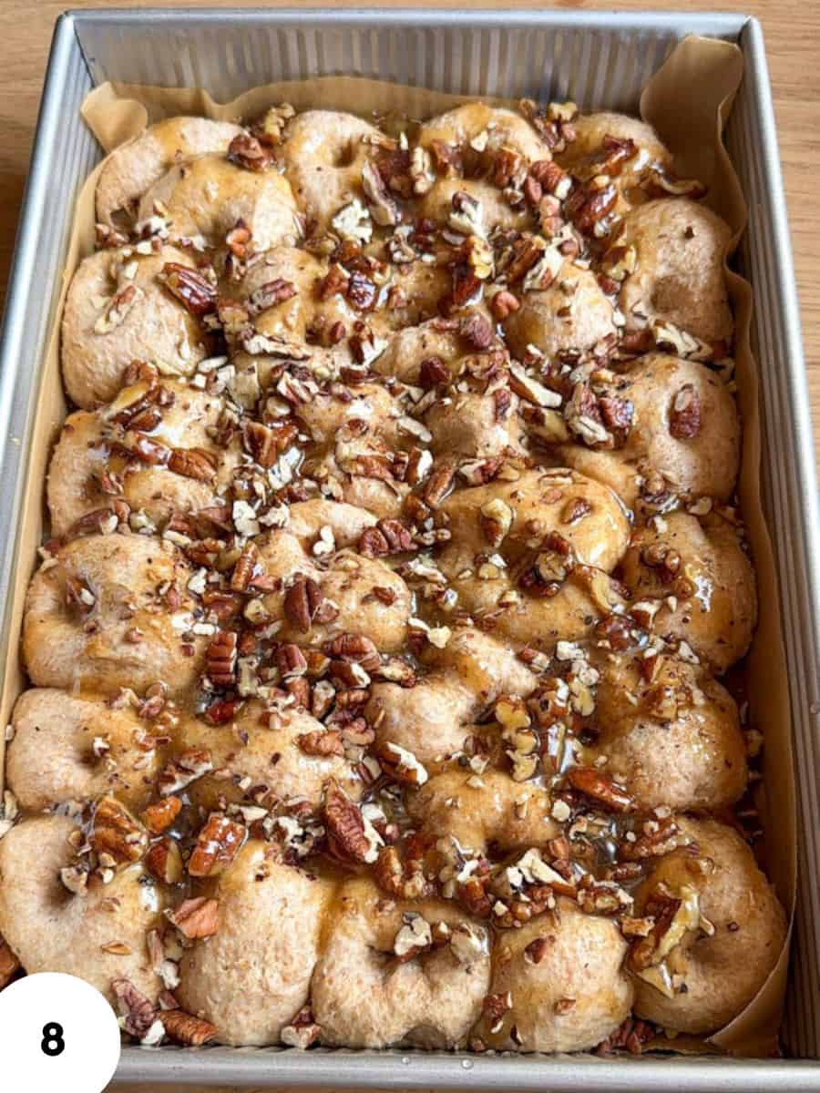 Sticky pecan pie pull-apart bread with chopped pecans and caramel glaze.