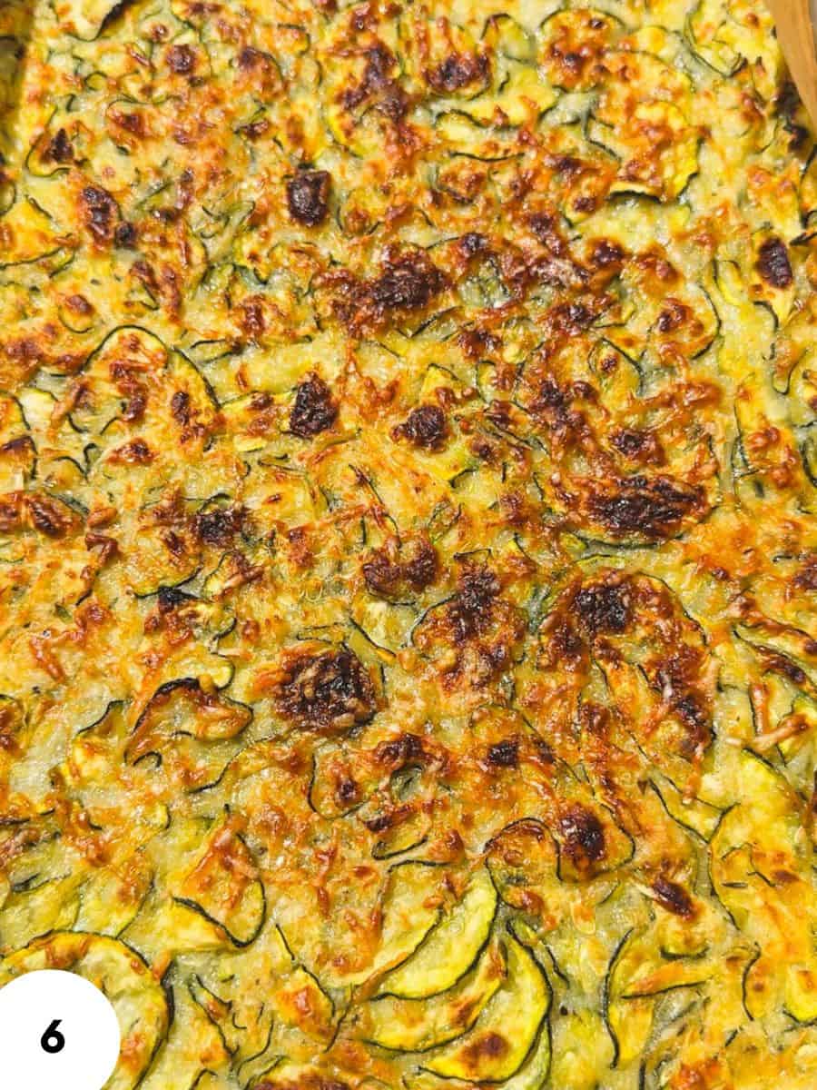 Close-up of crispy zucchini fritters with herbs and golden-brown edges.