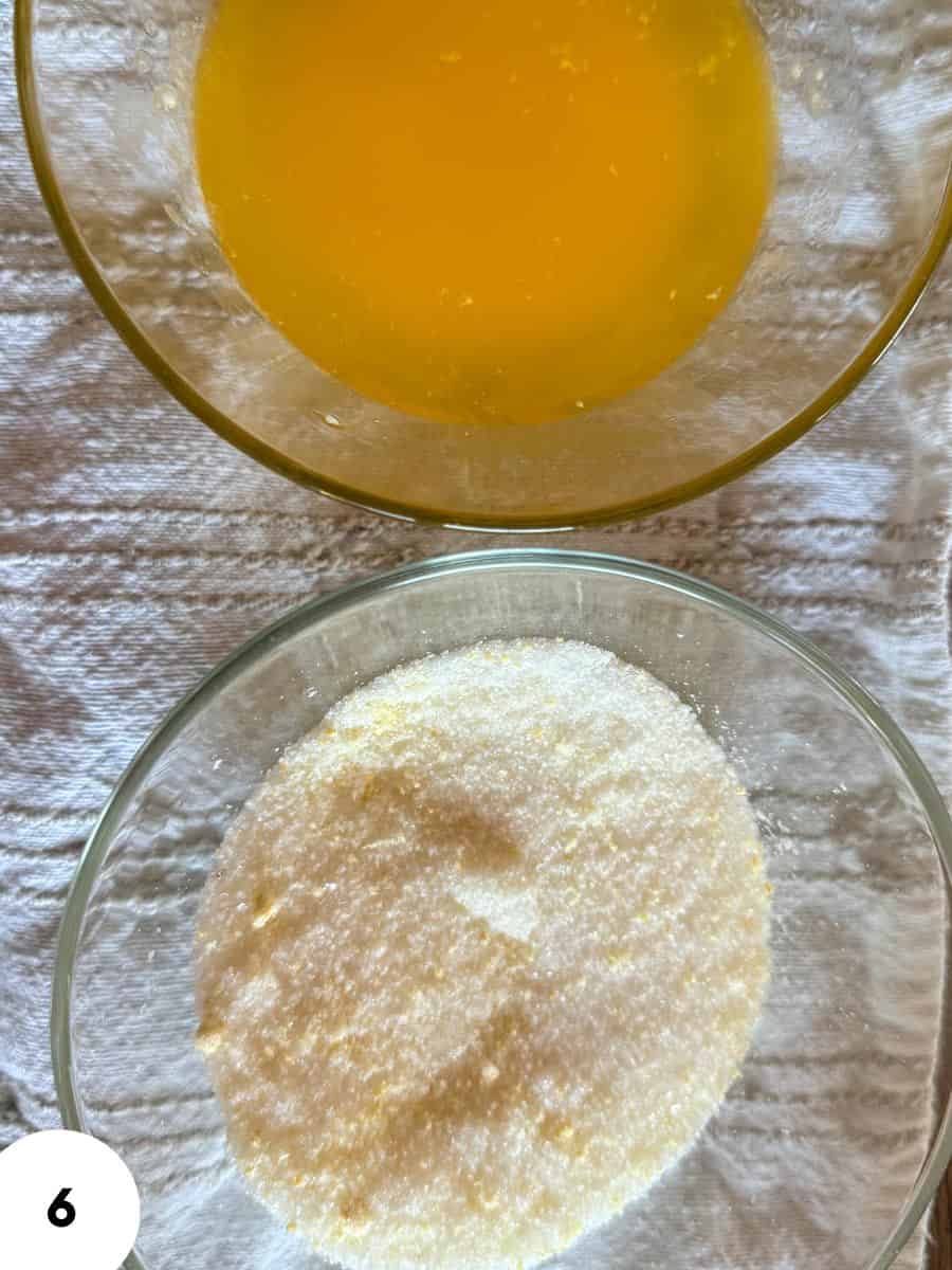 Bowl of beaten eggs and bowl of flour for bread dough.